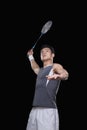 Man playing badminton, black background Royalty Free Stock Photo