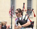 Man playing bagpipes closeup in a parade in small town America