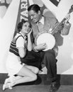 Man playing banjo for adoring woman