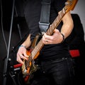 Man playing on a bass guitar, musical concert close up view. Royalty Free Stock Photo