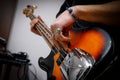 Man playing on a bass guitar, musical concert close up view. Royalty Free Stock Photo