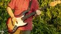 A man playing bass guitar in a Park Royalty Free Stock Photo