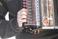 Man is playing on beautiful old harmonica accordion in winter nature Royalty Free Stock Photo