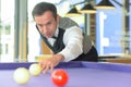 Man playing billiard in pool hall Royalty Free Stock Photo