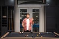 Man Playing billiard. Man trying to hit the ball in billiard in Billiard room. Russian pool billiards. Snooker Player