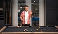 Man playing billiards in the billiard club.