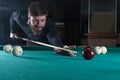 Man playing billiards. look at the ball. Royalty Free Stock Photo