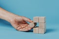 Man is playing with building blocks