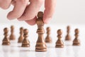 Man playing chess moving black king piece in a close up view