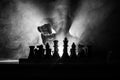 Man playing chess. Scary blurred silhouette of a person at the chessboard with chess figures. Dark toned foggy background.