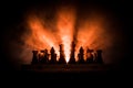 Man playing chess. Scary blurred silhouette of a person at the chessboard with chess figures. Dark toned foggy background.