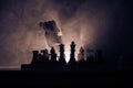 Man playing chess. Scary blurred silhouette of a person at the chessboard with chess figures. Dark toned foggy background.