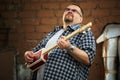 Man playing cigar box guitar Royalty Free Stock Photo