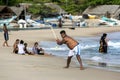 A man playing cricket on Arugam Bay beach in Sri Lanka. Royalty Free Stock Photo