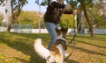 Man playing with the dog in the park Royalty Free Stock Photo