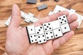 Man playing domino game. Close up. Hand holding domino pieces over table with domino game Royalty Free Stock Photo
