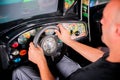 Man playing driving wheel video game Royalty Free Stock Photo