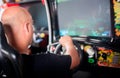 Man playing driving wheel video game Royalty Free Stock Photo