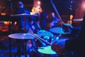 The man is playing drum set in low light background. Royalty Free Stock Photo