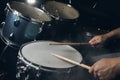 The man is playing drum set in low light background. Royalty Free Stock Photo