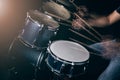The man is playing drum set in low light background. Royalty Free Stock Photo