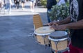 A man is playing drums on a sidewalk in front of a crowd. Royalty Free Stock Photo