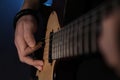 Man playing electric guitar on dark background, closeup. Rock music Royalty Free Stock Photo