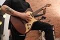 Man playing electric guitar during rehearsal in studio, closeup. Music band practice Royalty Free Stock Photo