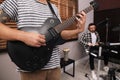 Man playing electric guitar during rehearsal in studio, closeup. Music band practice Royalty Free Stock Photo