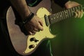 Man playing electric guitar on stage, closeup. Rock music Royalty Free Stock Photo