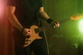 Man playing electric guitar on stage, closeup. Rock music Royalty Free Stock Photo