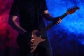 Man playing electric guitar on stage, closeup. Rock music Royalty Free Stock Photo