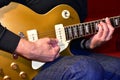 Man playing a gold top electric guitar. P90 pickups, body and neck details: Knobs, rosewood fretboard, switch, pickguard. Royalty Free Stock Photo