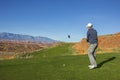 Man playing golf on a beautiful scenic desert golf course Royalty Free Stock Photo