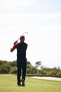 Man, playing and golf course with club for stroke, point or strike on grass field in nature. Rear view of male person or Royalty Free Stock Photo