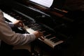 Man playing grand piano, closeup. Talented musician Royalty Free Stock Photo