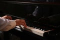 Man playing grand piano, closeup. Talented musician Royalty Free Stock Photo