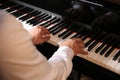 Man playing grand piano, closeup. Talented musician Royalty Free Stock Photo