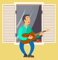 Man is playing the guitar on balcony of his house. Musician singing songs and sitting on windowsill