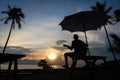 Man playing guitar on the beach with sunset Royalty Free Stock Photo