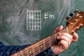 Man playing guitar chords displayed on a blackboard, Chord E minor Royalty Free Stock Photo
