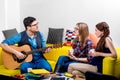 Man playing a guitar with girlfriends Royalty Free Stock Photo