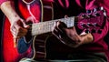 Man playing guitar, holding an acoustic guitar in his hands. Music concept. Male guitarist plays Royalty Free Stock Photo