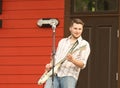 Man playing guitar and smiling during an outdoor concert Royalty Free Stock Photo