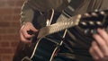 Man playing guitar on a stage. Musical concert. Close-up view. Royalty Free Stock Photo