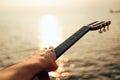 Man playing guitar on sunset sea beach Royalty Free Stock Photo