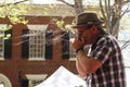 Man playing harmonica in hat at festival