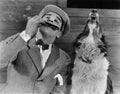 Man playing harmonica with howling dog Royalty Free Stock Photo