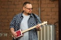 Man playing his cigar box guitar Royalty Free Stock Photo