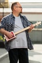 Man playing his cigar box guitar Royalty Free Stock Photo